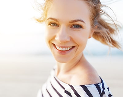 happy woman enjoying freedom and laughs on sea