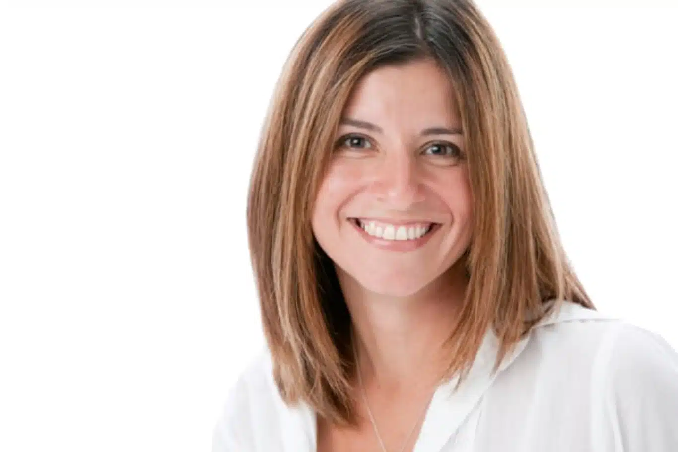 Portrait of a woman with medium length brown hair displaying an even radiant complexion after light based skin rejuvenation
