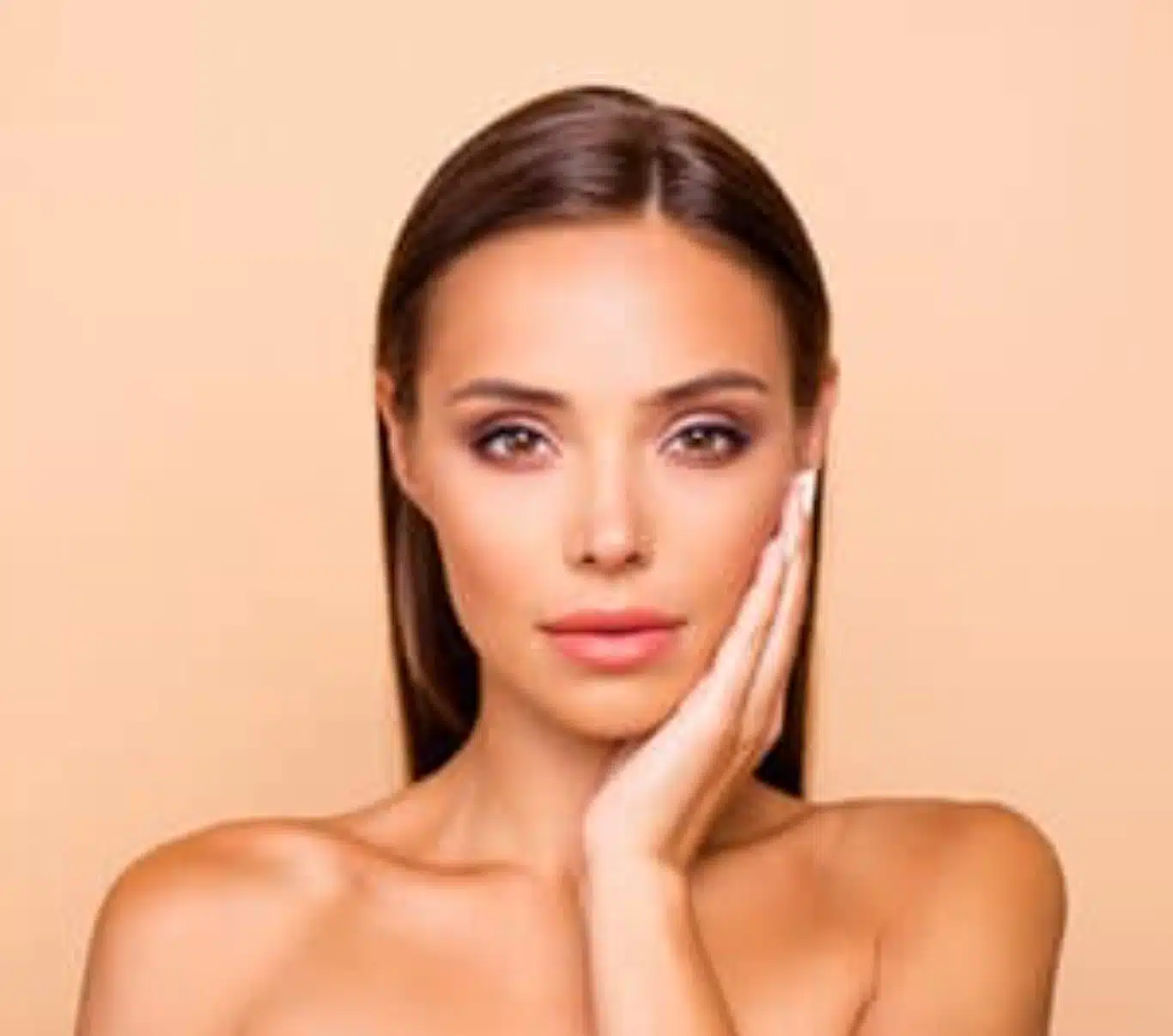 hydrafacial skin treatment glowing complexion Woman touching her cheek showcasing clear hydrated skin after a HydraFacial treatment